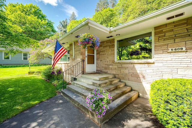 609 N Perkins Ave, Colfax, WA 99111 - view of exterior entry featuring a yard and stone siding
