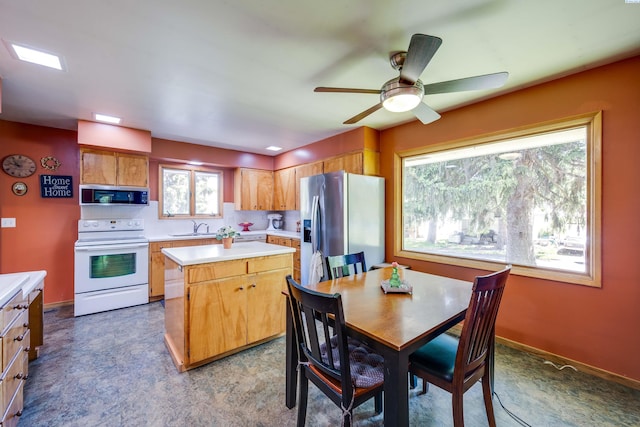 609 N Perkins Ave, Colfax, WA 99111 - kitchen featuring stainless steel appliances, a sink, light countertops, a center island, and ceiling fan