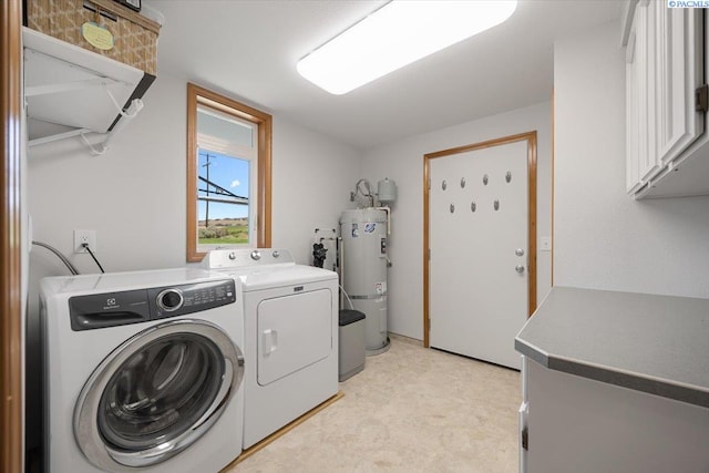 96604 E Clover Rd, Kennewick, WA 99338 - washroom with strapped water heater, independent washer and dryer, cabinet space, and light flooring