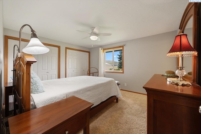 96604 E Clover Rd, Kennewick, WA 99338 - bedroom featuring two closets, carpet, and ceiling fan