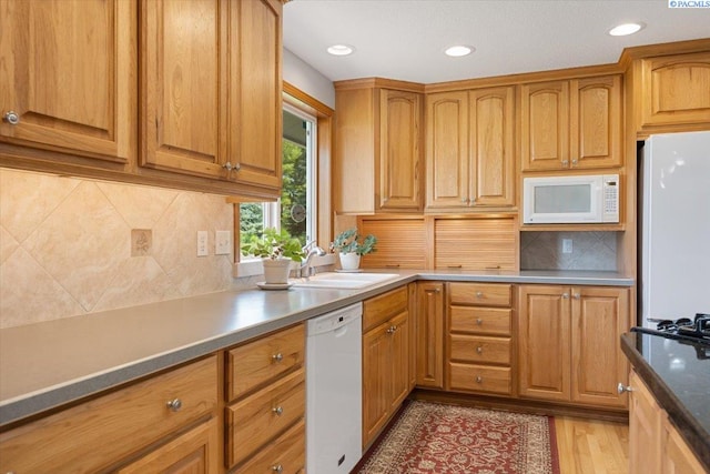 96604 E Clover Rd, Kennewick, WA 99338 - kitchen featuring white appliances, backsplash, light wood finished floors, recessed lighting, and brown cabinetry