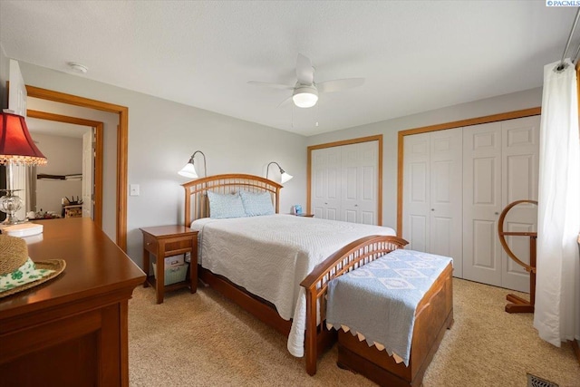 96604 E Clover Rd, Kennewick, WA 99338 - bedroom featuring light carpet, two closets, and ceiling fan