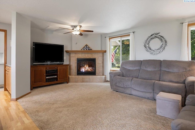 96604 E Clover Rd, Kennewick, WA 99338 - living room with ceiling fan, a fireplace, and light wood-style flooring