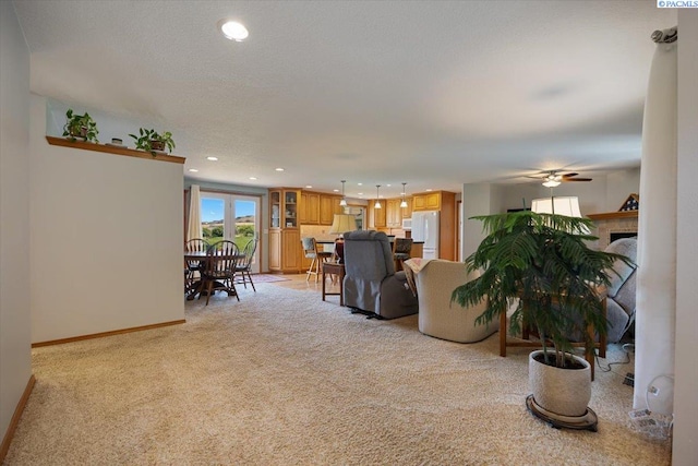 96604 E Clover Rd, Kennewick, WA 99338 - living room featuring light colored carpet, recessed lighting, ceiling fan, and a fireplace