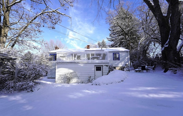 view of snow covered rear of property