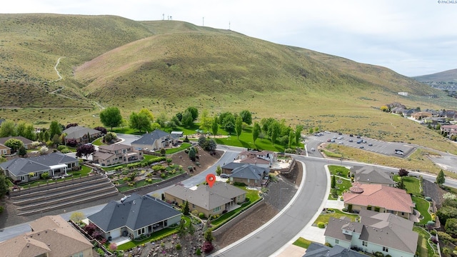 drone / aerial view featuring a residential view and a mountain view