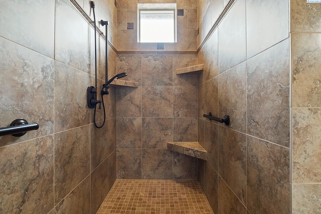 bathroom featuring a tile shower