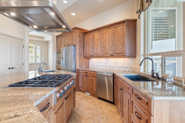 kitchen featuring a sink, light stone counters, stainless steel appliances, and island exhaust hood