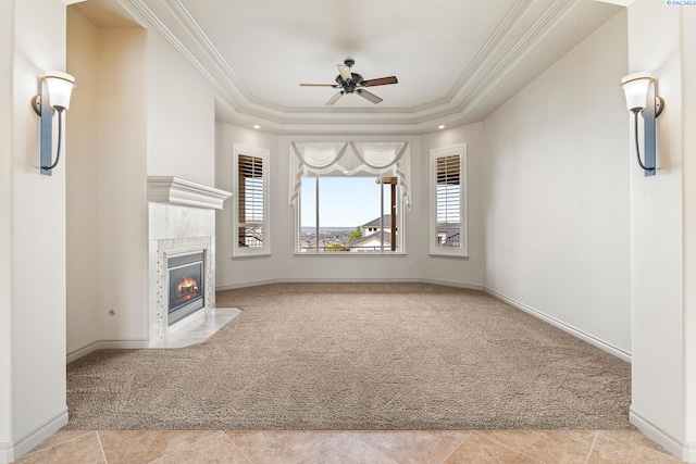 unfurnished living room featuring crown molding, carpet, and a tile fireplace