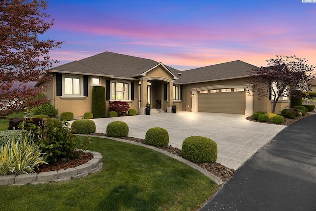ranch-style home featuring curved driveway, a shingled roof, an attached garage, and stucco siding