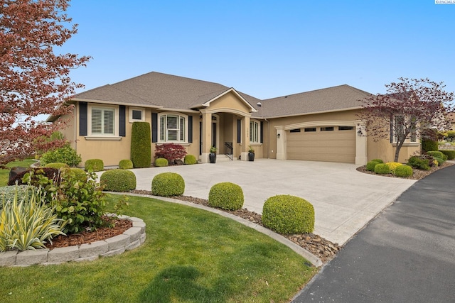 ranch-style house featuring a garage, a front lawn, stucco siding, and driveway