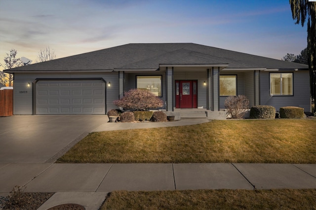 view of front facade featuring a yard and a garage