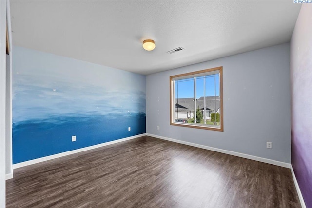 empty room with wood finished floors and baseboards