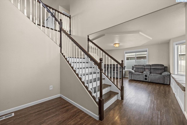 stairway featuring wood finished floors and baseboards