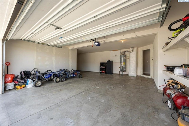 garage with a garage door opener and secured water heater