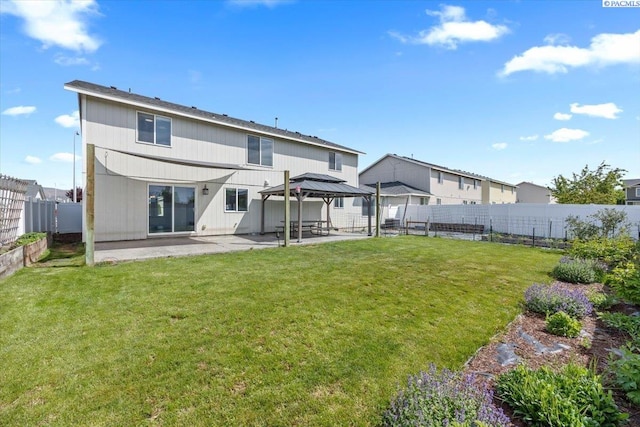 back of property with a gazebo and a patio