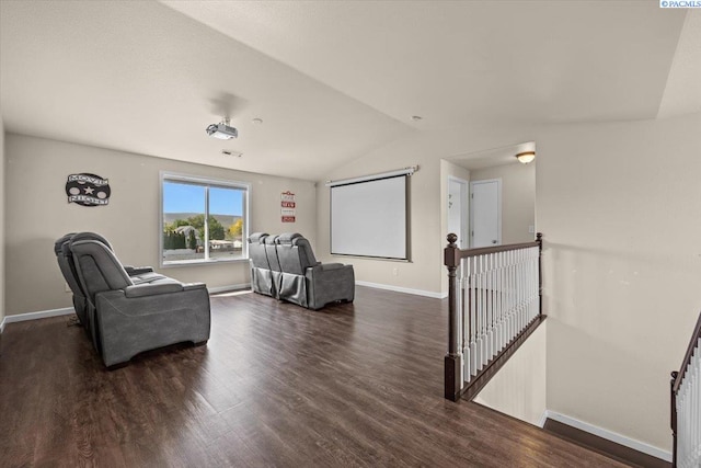 sitting room featuring an upstairs landing, wood finished floors, lofted ceiling, and baseboards