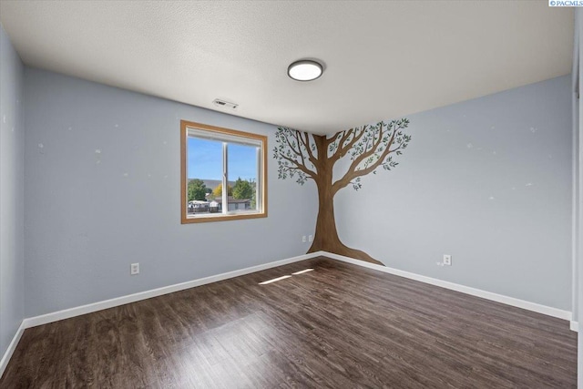 empty room with wood finished floors and baseboards