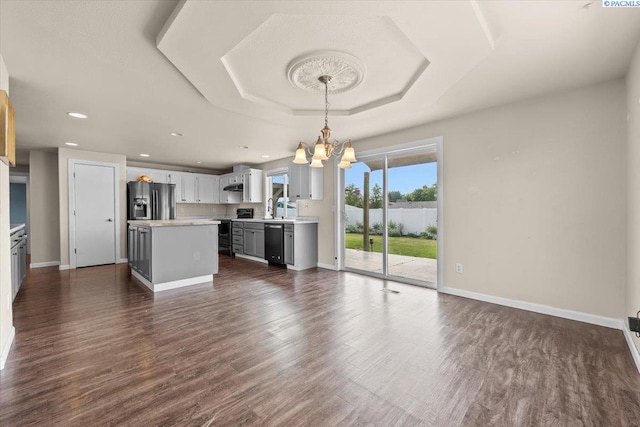 kitchen featuring black dishwasher, electric range, stainless steel fridge with ice dispenser, a chandelier, and light countertops