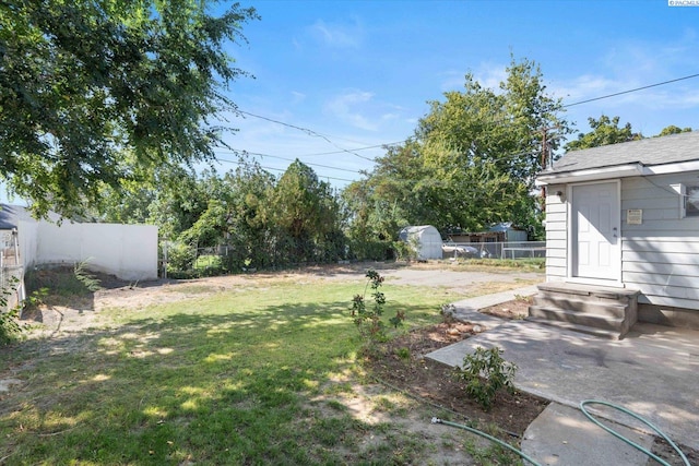 view of yard with a patio and a shed