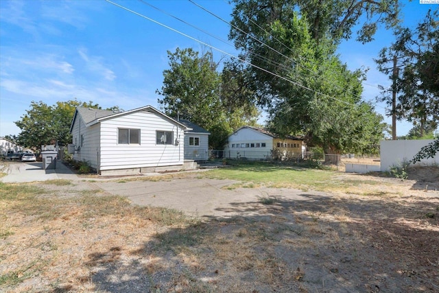 rear view of property featuring a yard