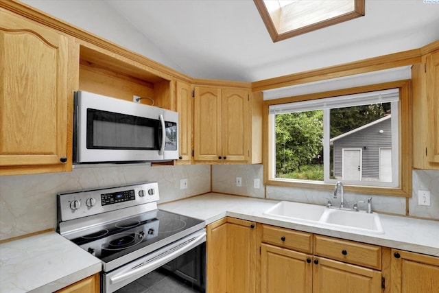 807 N Main St, Colfax, WA 99111 - kitchen with stainless steel electric range, a sink, vaulted ceiling, decorative backsplash, and light countertops
