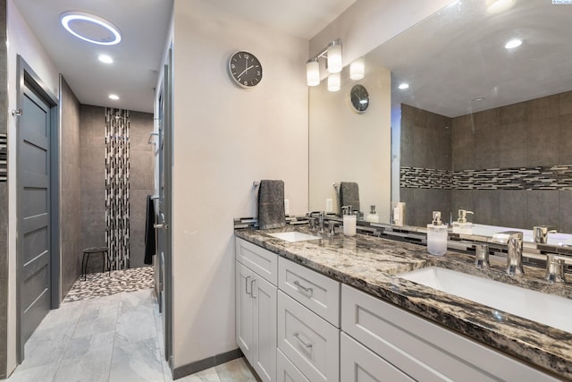 9115 W Maple Dr, Pasco, WA 99301 - full bath with double vanity, a tile shower, recessed lighting, and marble finish flooring