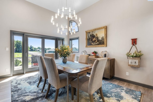 9115 W Maple Dr, Pasco, WA 99301 - dining space with a chandelier, healthy amount of natural light, wood finished floors, and a high ceiling
