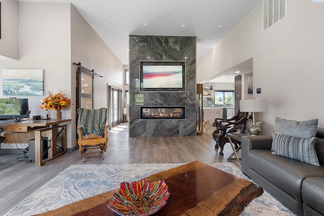 9115 W Maple Dr, Pasco, WA 99301 - living room featuring a towering ceiling, wood finished floors, an office area, a fireplace, and recessed lighting