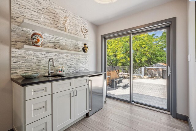 9115 W Maple Dr, Pasco, WA 99301 - kitchen with fridge, backsplash, open shelves, dark countertops, and white cabinets