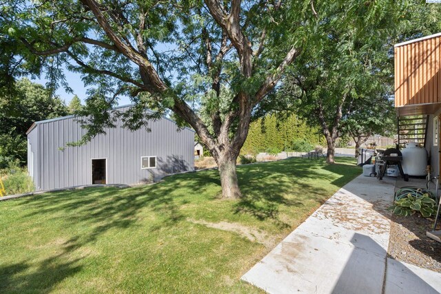 9115 W Maple Dr, Pasco, WA 99301 - view of grassy yard featuring an outbuilding, stairway, an outdoor structure, and a patio