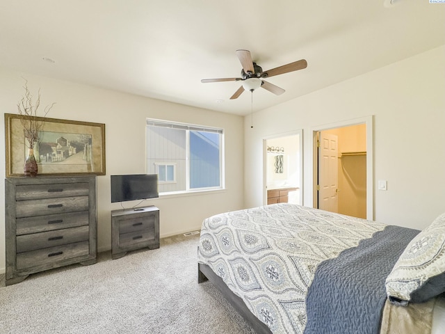 bedroom with carpet floors, ensuite bath, and ceiling fan