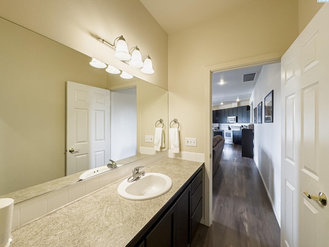 bathroom with vanity, wood finished floors, and visible vents