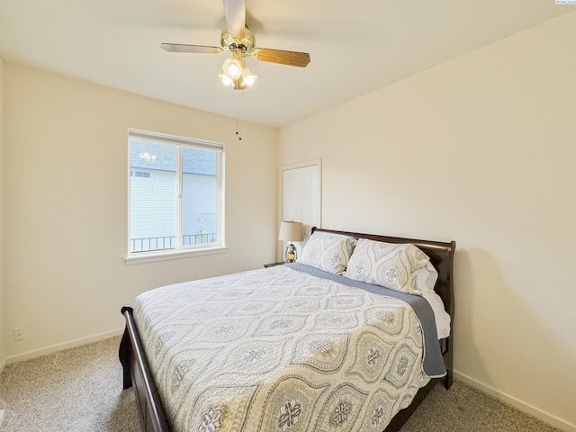 bedroom with ceiling fan, baseboards, and carpet flooring