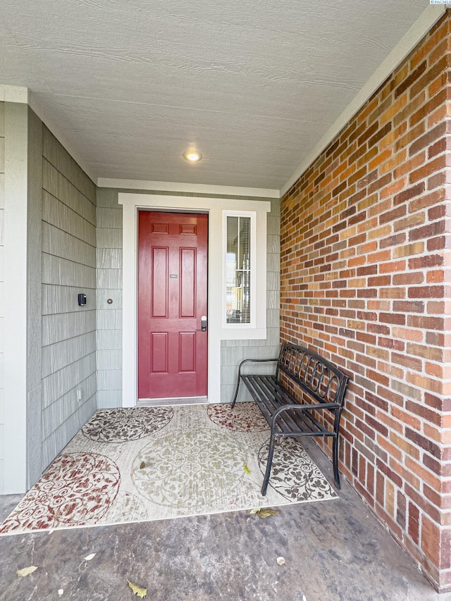 view of exterior entry with brick siding