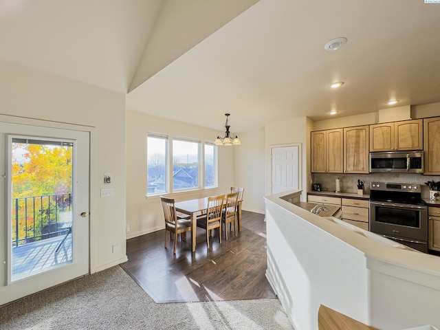 kitchen featuring tasteful backsplash, dark wood-style flooring, an inviting chandelier, stainless steel appliances, and pendant lighting