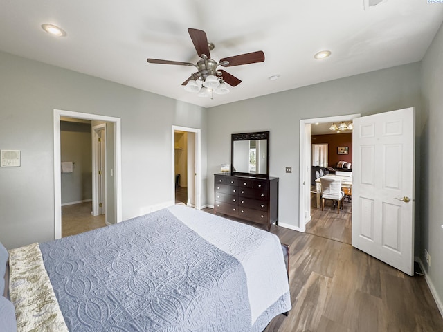 bedroom featuring a ceiling fan, recessed lighting, baseboards, and wood finished floors