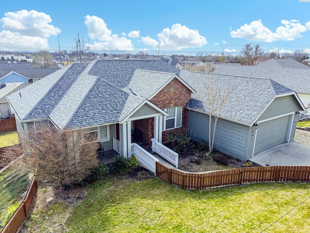 view of front of home featuring a front yard, fence, and roof with shingles