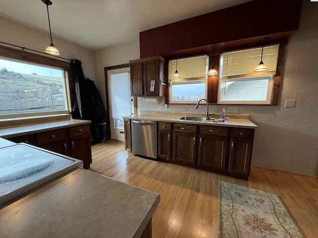 408 S Mill St, Colfax, WA 99111 - kitchen with stainless steel dishwasher, light wood-style floors, dark brown cabinets, and a textured wall