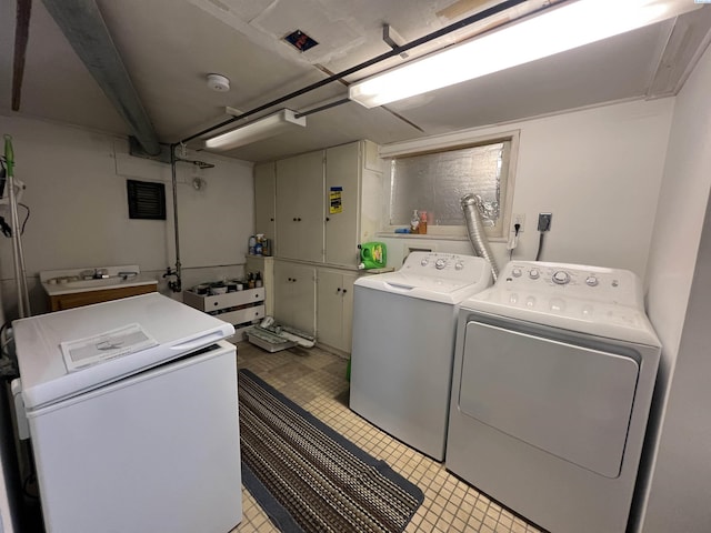 408 S Mill St, Colfax, WA 99111 - washroom featuring washing machine and dryer and light tile patterned floors