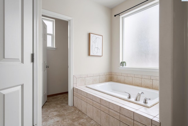 bathroom featuring tiled tub