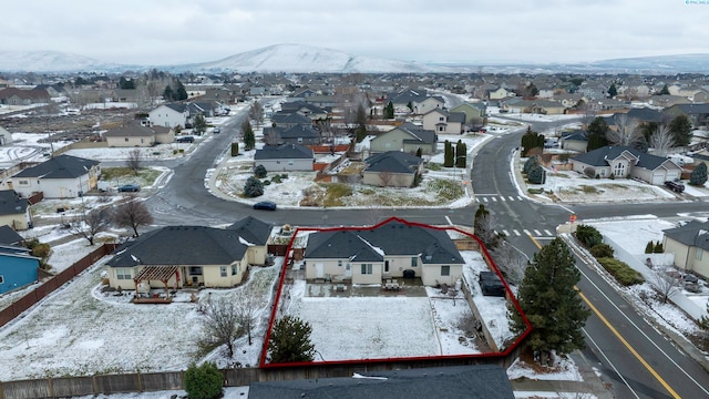 snowy aerial view featuring a mountain view