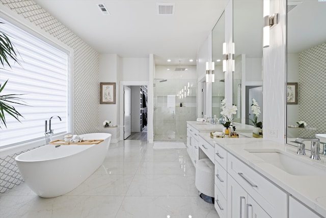 bathroom featuring vanity and shower with separate bathtub