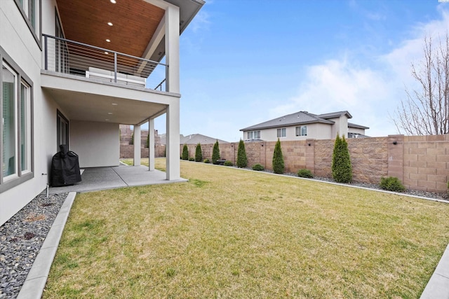 view of yard featuring a patio area and a balcony