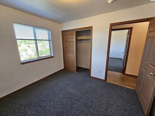 1135-1137 NE Indiana St, Pullman, WA 99163 - unfurnished bedroom featuring baseboards, dark carpet, and a closet
