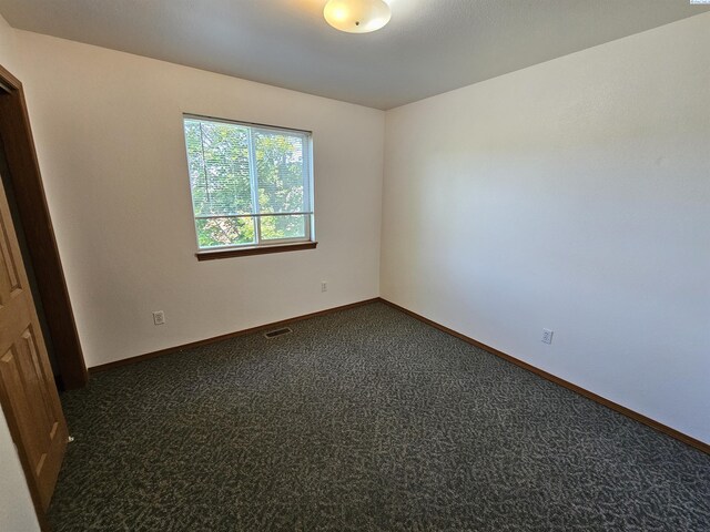 1135-1137 NE Indiana St, Pullman, WA 99163 - empty room with baseboards, visible vents, and dark carpet