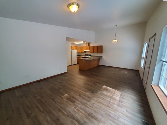 1135-1137 NE Indiana St, Pullman, WA 99163 - unfurnished living room featuring baseboards, dark wood finished floors, lofted ceiling, and visible vents