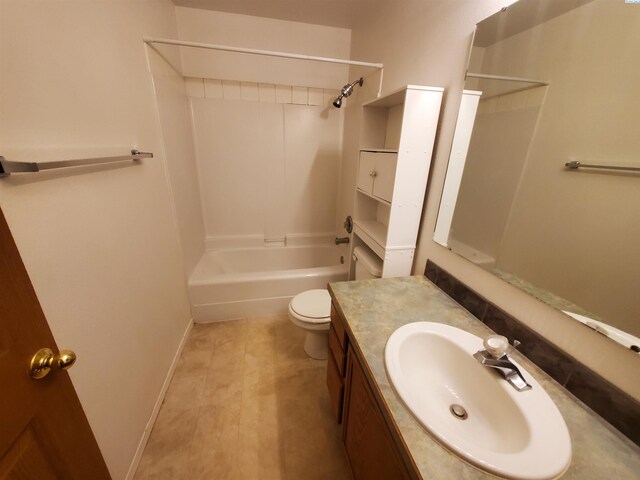 1135-1137 NE Indiana St, Pullman, WA 99163 - full bathroom featuring vanity, tile patterned flooring, toilet, baseboards, and shower / bathing tub combination