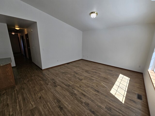 1135-1137 NE Indiana St, Pullman, WA 99163 - spare room with baseboards, visible vents, and dark wood-style floors