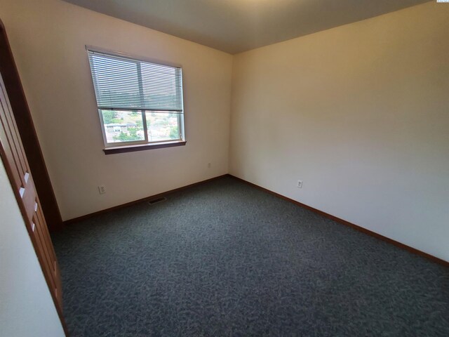 1135-1137 NE Indiana St, Pullman, WA 99163 - empty room featuring baseboards, visible vents, and dark carpet